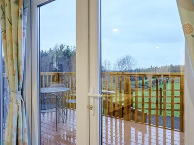 a sliding glass door with a view of a deck at The Paddocks - Uk7112 in Alloa