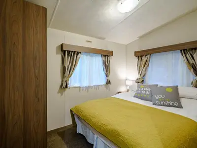 a bedroom with a bed with yellow sheets and a window at The Orchard - Uk7111 in Alloa