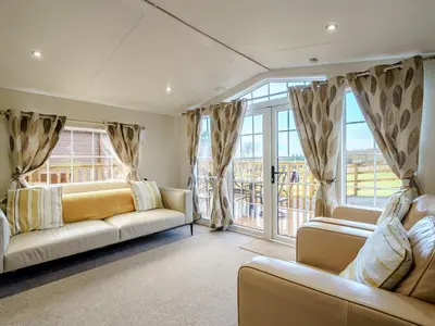 a living room with two couches and large windows at The Orchard - Uk7111 in Alloa