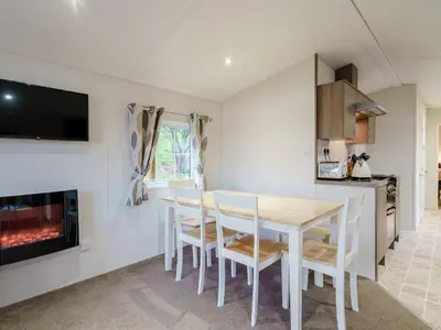 a kitchen and dining room with a table and chairs at The Orchard - Uk7111 in Alloa