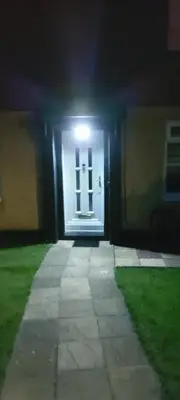 a front door of a house with a light at night at LAWFIELD R&R in West Kilbride