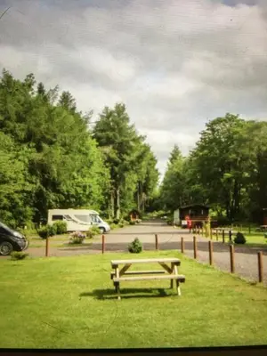 a picnic table in the grass in a park at Chalet 2 in Tyndrum