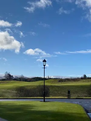 a lamp post in the middle of a golf course at Gleneagles Luxury Apartment in Auchterarder