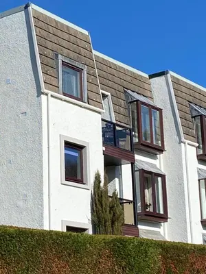 an apartment building with windows and a roof at Gleneagles Luxury Apartment in Auchterarder