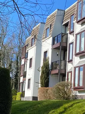 an apartment building with a green lawn in front of it at Gleneagles Luxury Apartment in Auchterarder