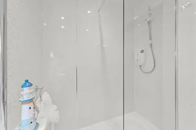 a bathroom with a shower with a glass door at The Ploughman's Poet in Bathgate
