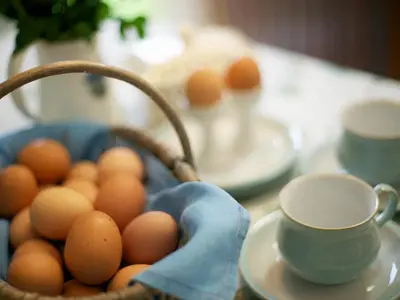 a basket of eggs on a table with a cup at The Bothy in Haywood