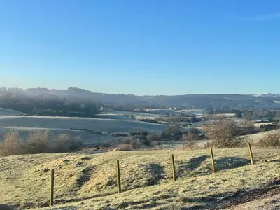 a field with snow on the ground and a fence at South Barlogan Farm in Bridge of Weir