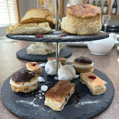 two tiers of pastries and ice cream on a table at Blackbull hotel in Tarbolton