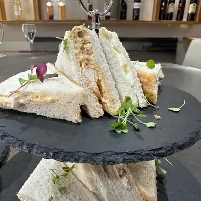 a group of sandwiches on a plate on a table at Blackbull hotel in Tarbolton