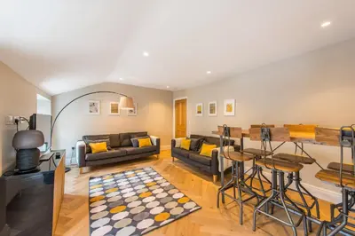 a living room with a couch and a table at City Centre, Newly Refurbished Stylish Apartment in Edinburgh