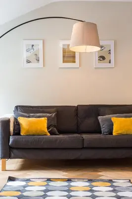 a living room with a couch with yellow pillows at City Centre, Newly Refurbished Stylish Apartment in Edinburgh