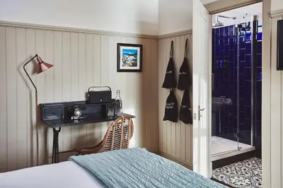 a bedroom with a shower and a bed and a camera at No.26 By The Sea in Oban