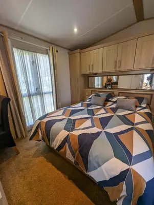 a bedroom with a bed with a colorful comforter at The Ashcroft Sea View 6 in Dunoon