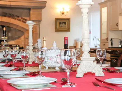 a table with wine glasses and wine bottles on it at Auchentroig House in Stirling