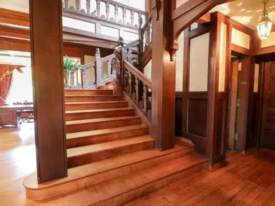 a wooden staircase in a home with wooden floors at Auchentroig House in Stirling
