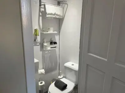 a small bathroom with a toilet and a sink at Peacock Guest House in Largs