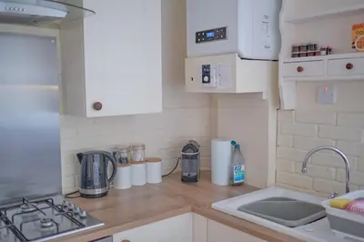 a kitchen with a sink and a counter top at Old Spittal Hospital Apartment - Free Parking in Stirling