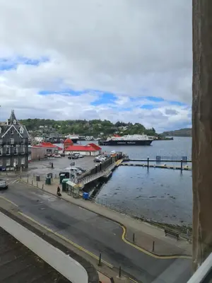 a view of a harbor with a boat in the water at The Editor's Choice, Oban seafront apartment in Oban