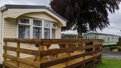 a house with a wooden fence in front of it at Lyndhurst Corner 72 in Dunoon