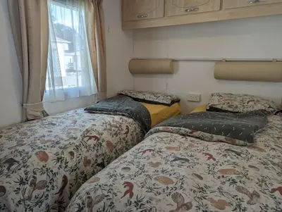 two beds sitting next to each other in a room at 34 Glenfinart Park in Dunoon