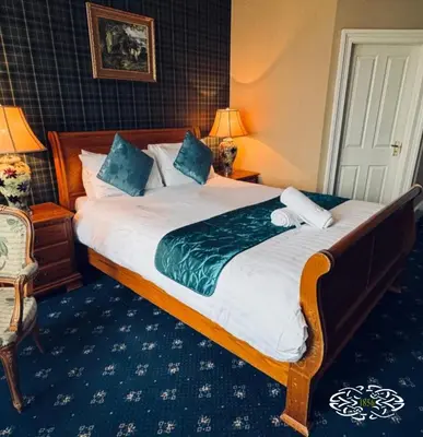 a bedroom with a large bed in a hotel room at Royal Marine Hotel Dunoon in Kirn