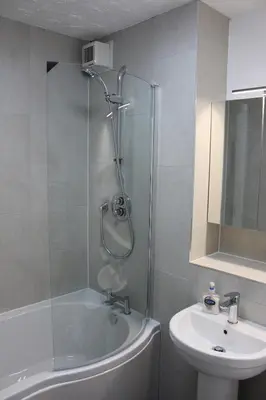 a bathroom with a shower and a toilet and a sink at Riverside Apartment in Ayr