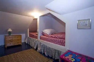 a bedroom with two twin beds in a room at Caberfeidh Cottage in Bruichladdich