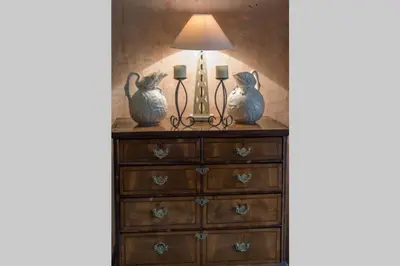 a dresser with two vases and a lamp on it at Queen Mary's Chamber in Peebles