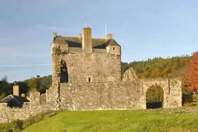 an old castle sitting on top of a grass field at Queen Mary's Chamber in Peebles