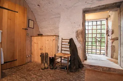 a room with a wooden chair and a window at Barns Tower in Peebles