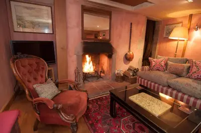 a living room with a couch and a fireplace at Barns Tower in Peebles