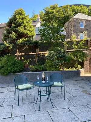 two chairs and a table on a patio at Ardmor Guest House in Oban