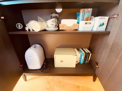 a shelf with a sewing machine and books on it at Ardmor Guest House in Oban