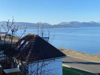 a roof of a building next to a body of water at The Wee Cottage by the Ferry in Gourock