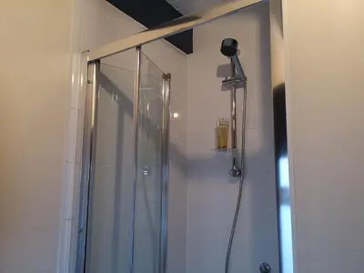 a shower with a glass door in a bathroom at The Bothy Claymires Loch Lomond & Stirling in Buchlyvie