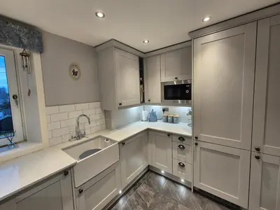 a kitchen with white cabinets and a sink at Brae View Coastal Gem in Largs