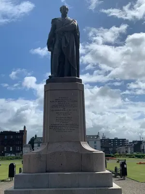 a statue of a man standing in a park at Ayr Apartment with Sea and Countryside views in Ayr
