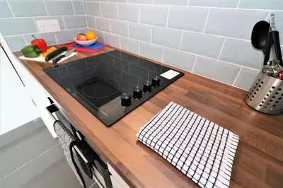 a kitchen counter with a sink and a cutting board at Signature - Newbattle House in Chapelhall