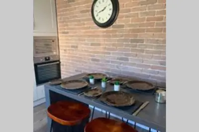 a kitchen with pies on a counter with a clock on the wall at Creag Mhor Self Catering Holiday Apartment in Aberfoyle