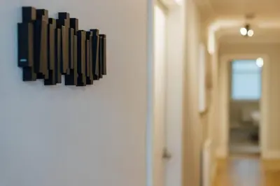 a bunch of black objects hanging on a wall at Glasgow Central Luxury Apartment in Glasgow
