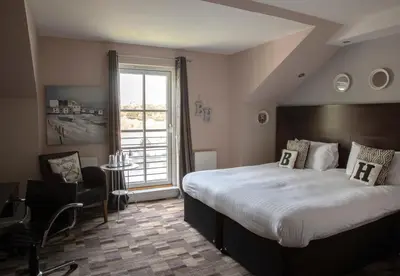 a bedroom with a large bed and a large window at The Boat House in Kilsyth