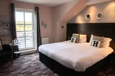 a bedroom with a large bed with a large window at The Boat House in Kilsyth