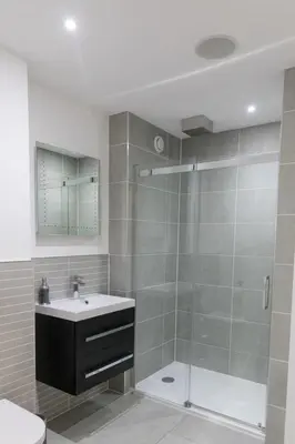 a bathroom with a glass shower and a sink at 1 Bed Studio - Sleeps 4 - Parking - Wifi in Saint Davids