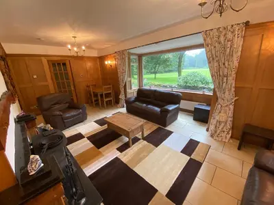 a living room with a couch and a table at Country Cottage Sleeps 6 w Hot Tub & Dog-Friendly in Moniaive