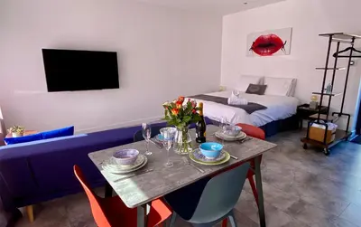 a room with a dining table and a bed at Dalgety Bay Luxury Studio Apartment in Saint Davids