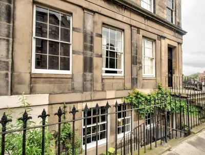 a building with windows and a fence in front of it at Hamilton Place - Beautiful and central city apartment with private entrance sleeps 4 in Edinburgh