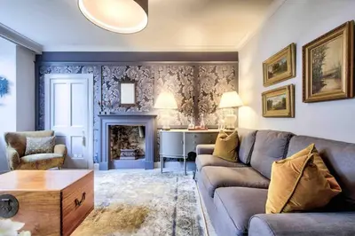 a living room with a couch and a fireplace at Hamilton Place - Beautiful and central city apartment with private entrance sleeps 4 in Edinburgh
