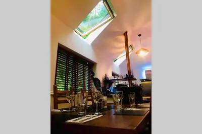 a dining room with a table with glasses on it at North Lodge Kilmun in Kilmun