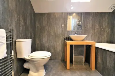 a bathroom with a toilet and a sink at Signature - Linden Cottage Room 3 in Airdrie